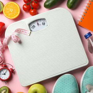 Weight loss or healthy lifestyle accessories on pink background